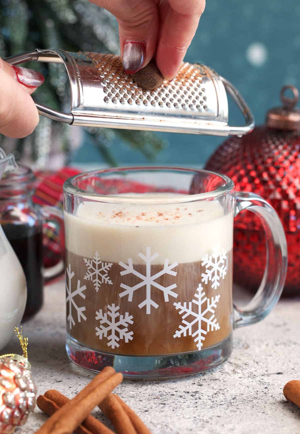 nutmeg being grated over an easy nutmeg latte recipe