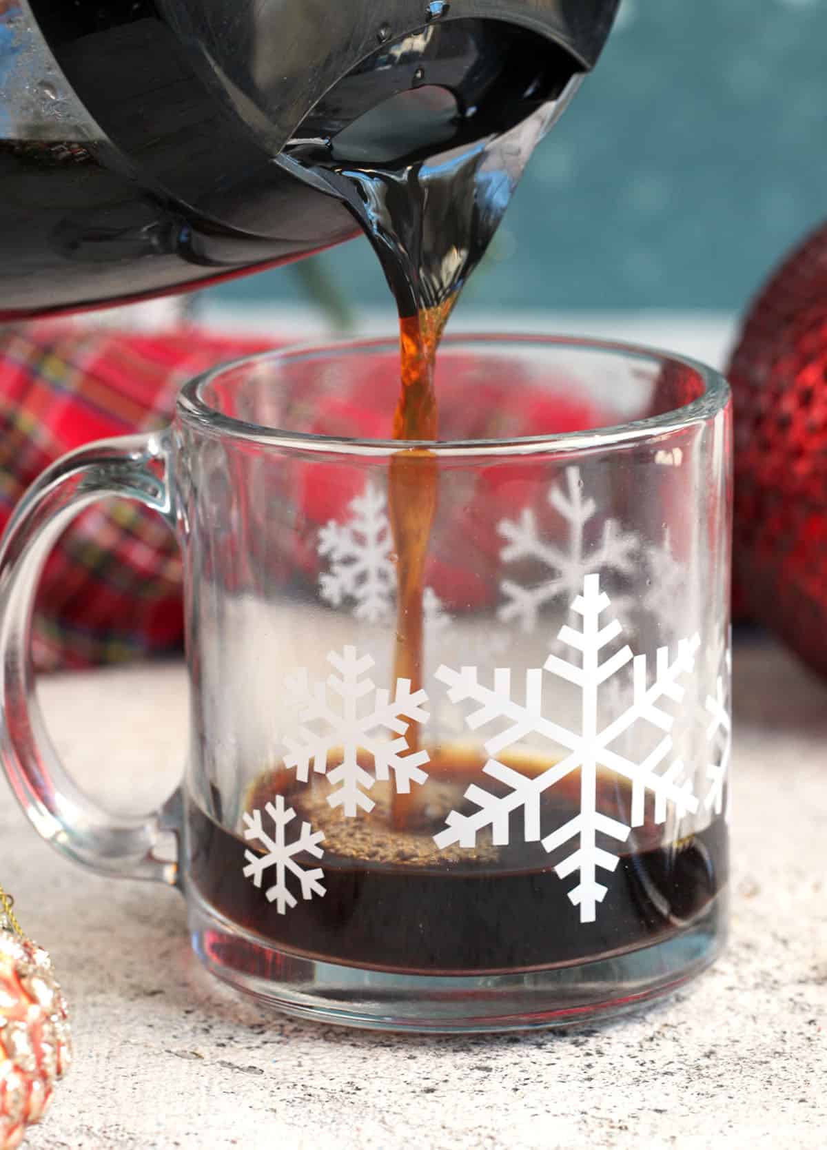 coffee being poured into a glass mug for a christmas coffee drink