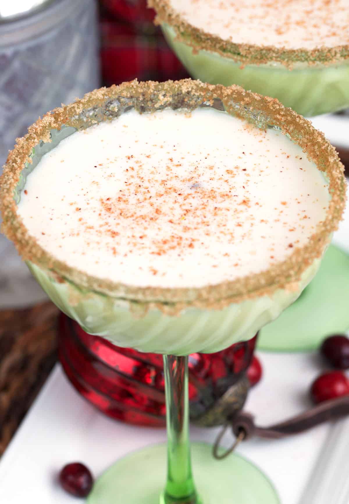 Eggnog martini with grated nutmeg on top for a festive holiday cocktail