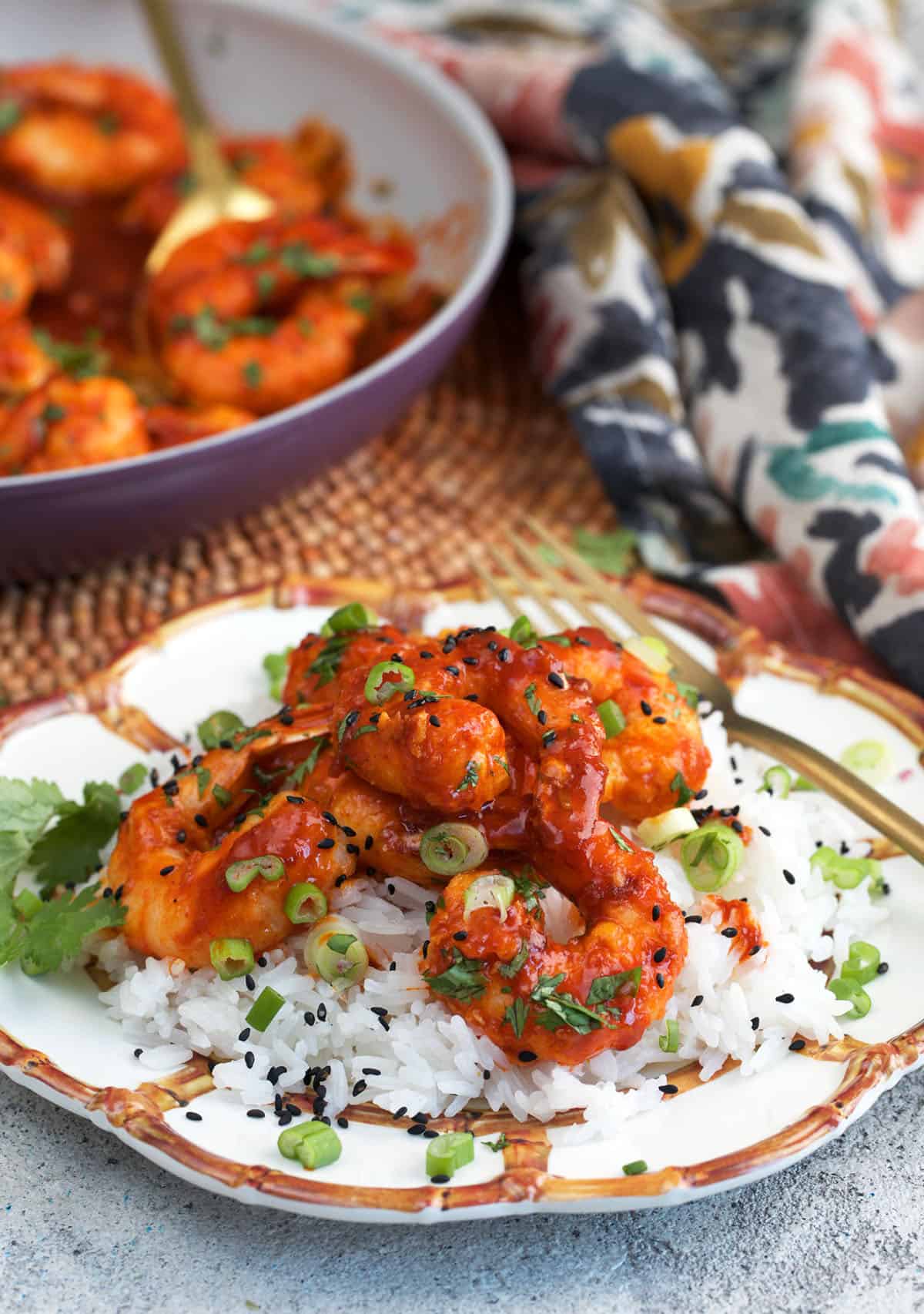 Firecracker Shrimp on a pile of rice on a bamboo plate