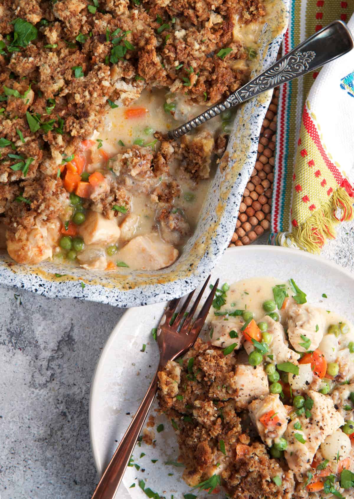 Chicken Stuffing Casserole in a baking dish with a serving on a plate