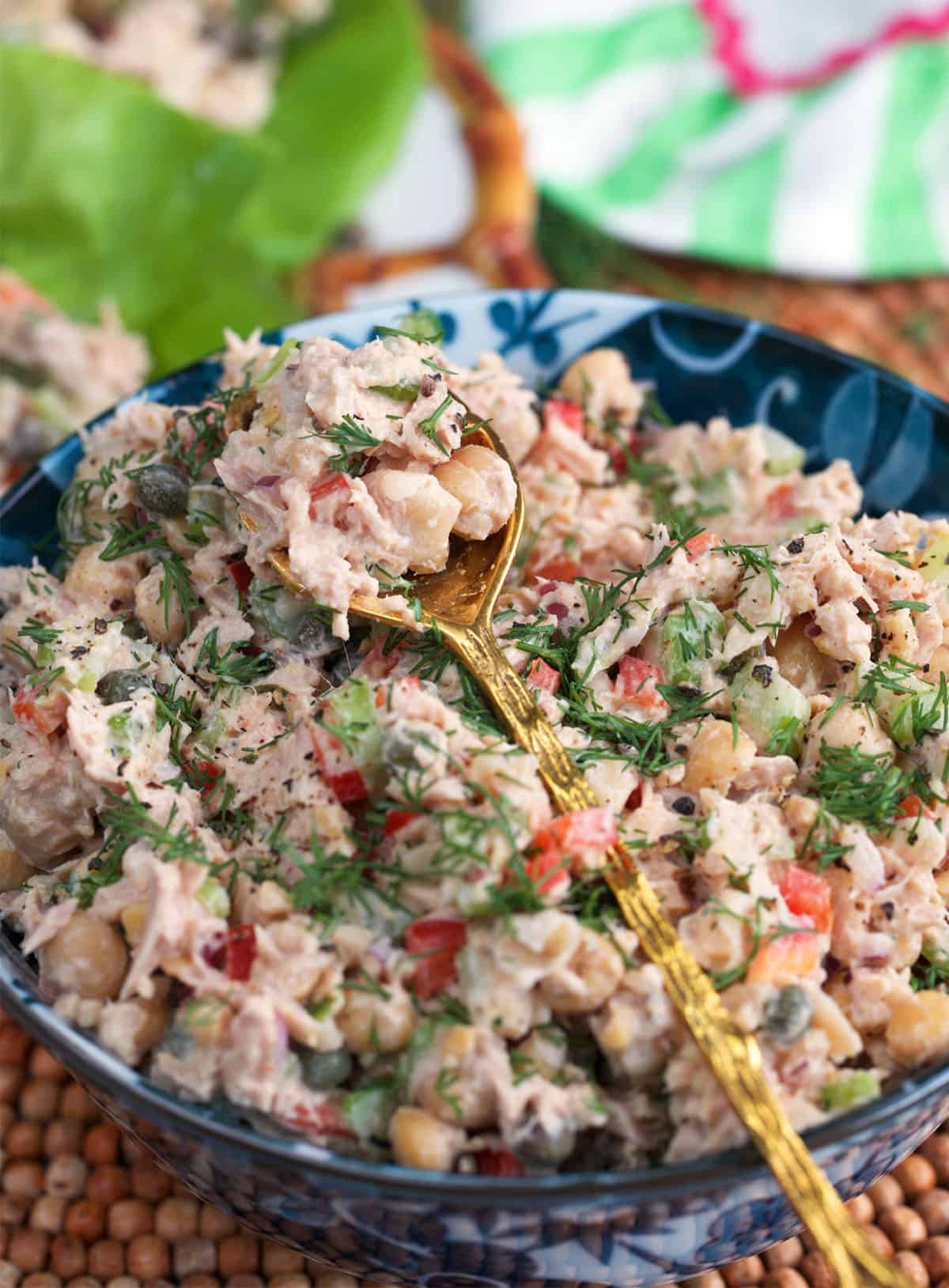 chickpea tuna salad in a bowl with a gold serving spoon