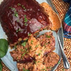 Marry Me Meatloaf on a platter with tuscan gravy