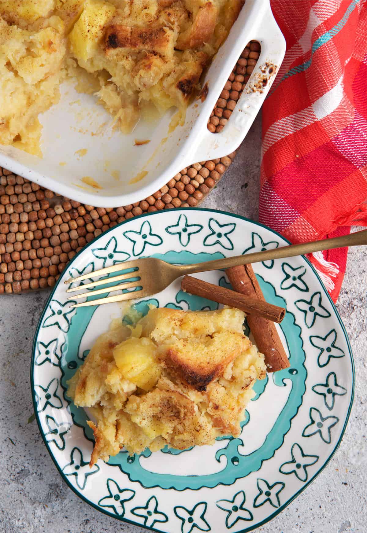 Pineapple stuffing on a pretty turquoise and white plate with a gold fork and cinnamon sticks.