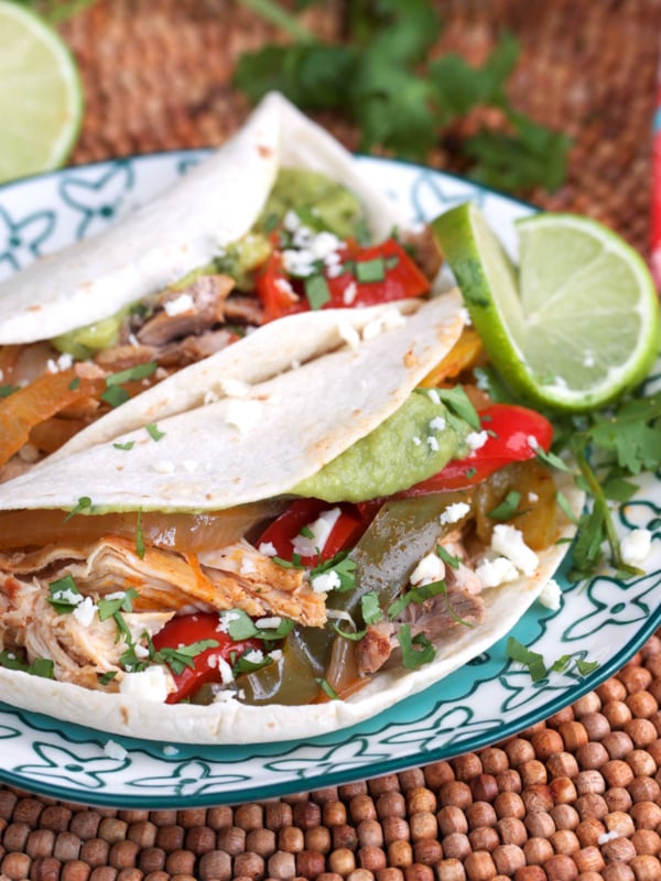 Crockpot chicken Fajitas plated with lime and cojita cheese.