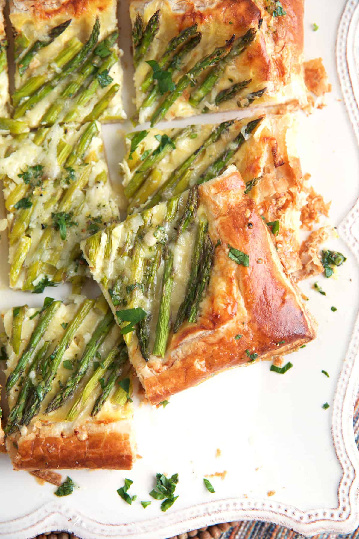 Asparagus tart made with puff pastry cut into squares and ready to serve.