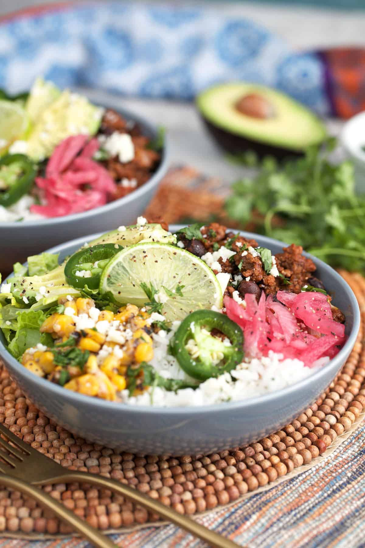 Beef Taco Bowls with avocado, corn, black beans and cheese.