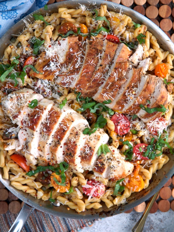 Bruschetta Chicken pasta in a large skillet ready to be served.