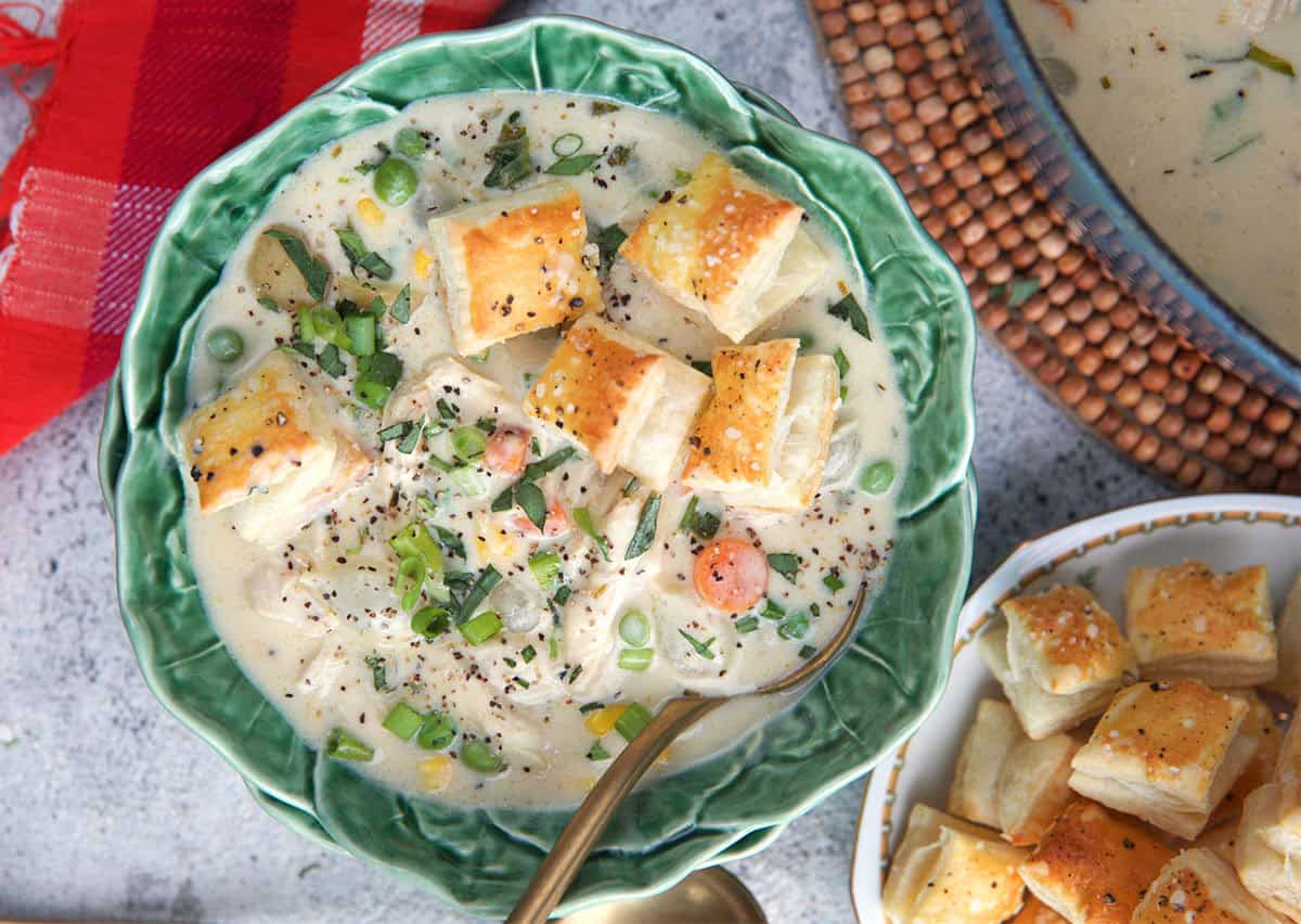 Chicken Pot Pie soup served in a cabbage bowl and topped with puff pastry croutons.