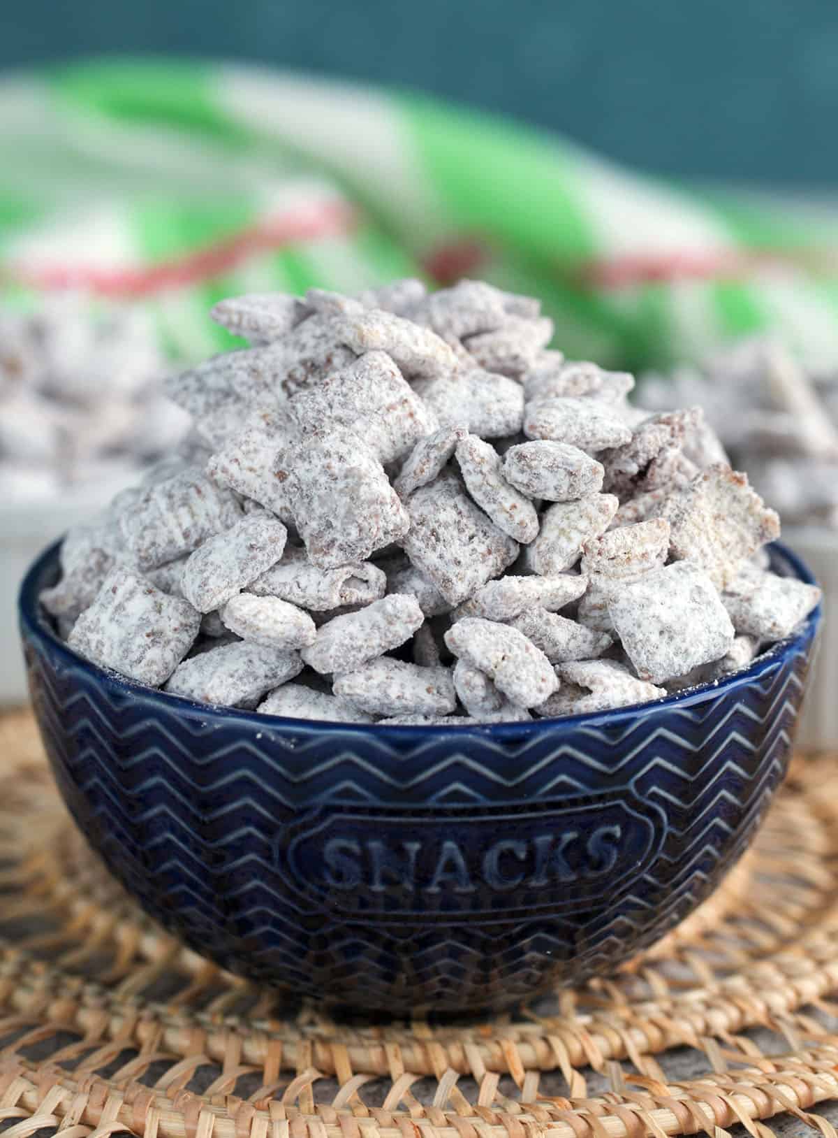 Muddy Buddies in a blue bowl for serving.