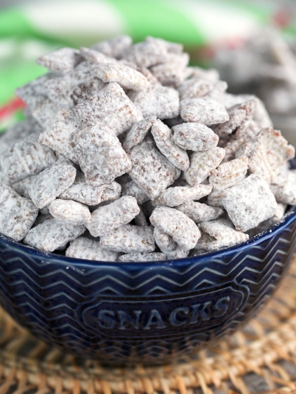Easy Muddy Buddies recipe in a blue bowl for serving.