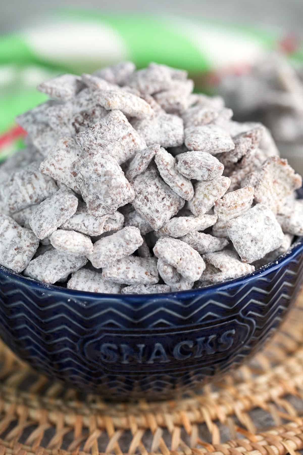 Easy Muddy Buddies recipe in a blue bowl for serving.
