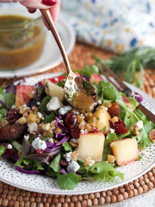 Red Wine Vinaigrette being spooned over a salad.