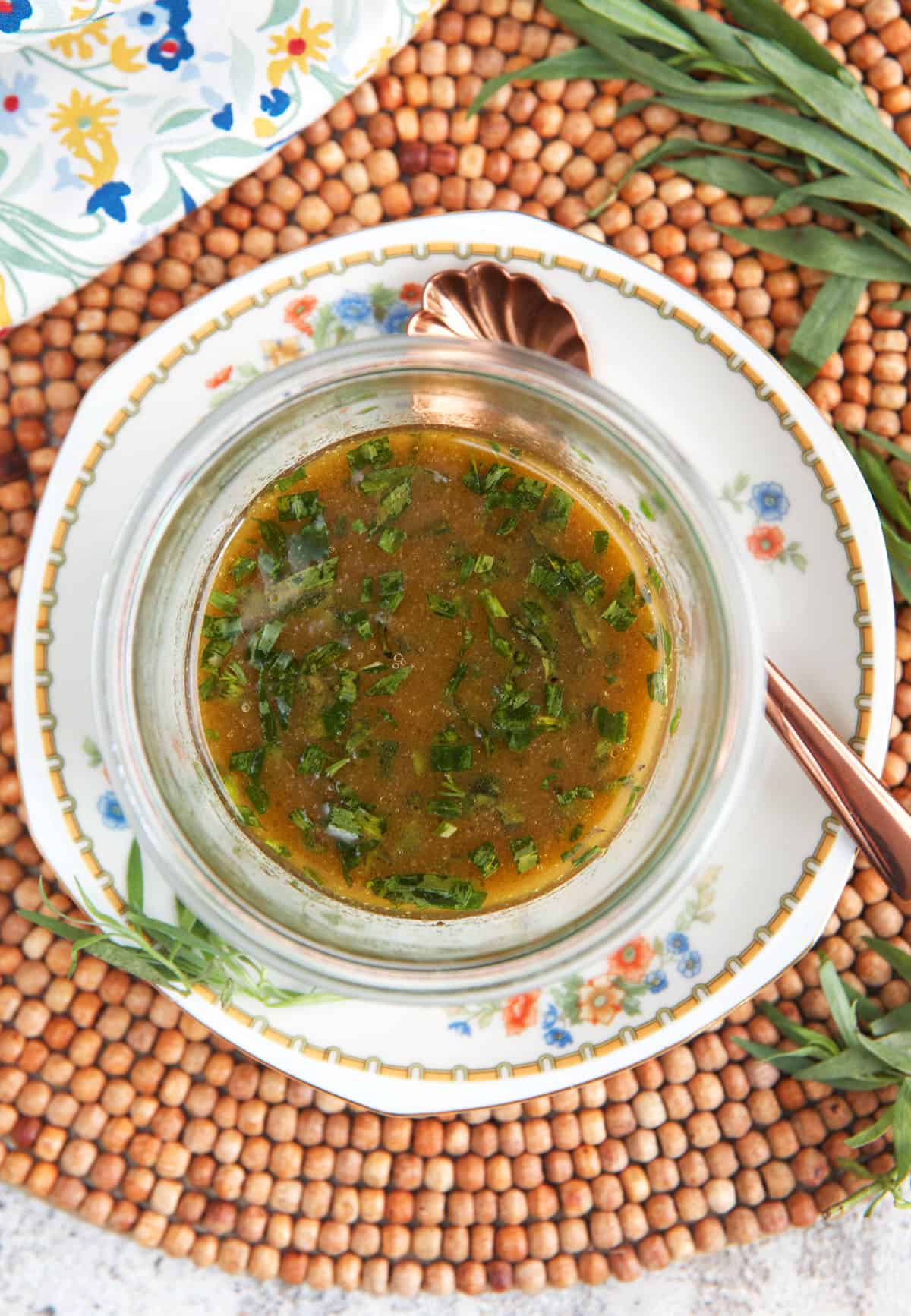 Red wine vinaigrette in a glass dish with a serving spoon.