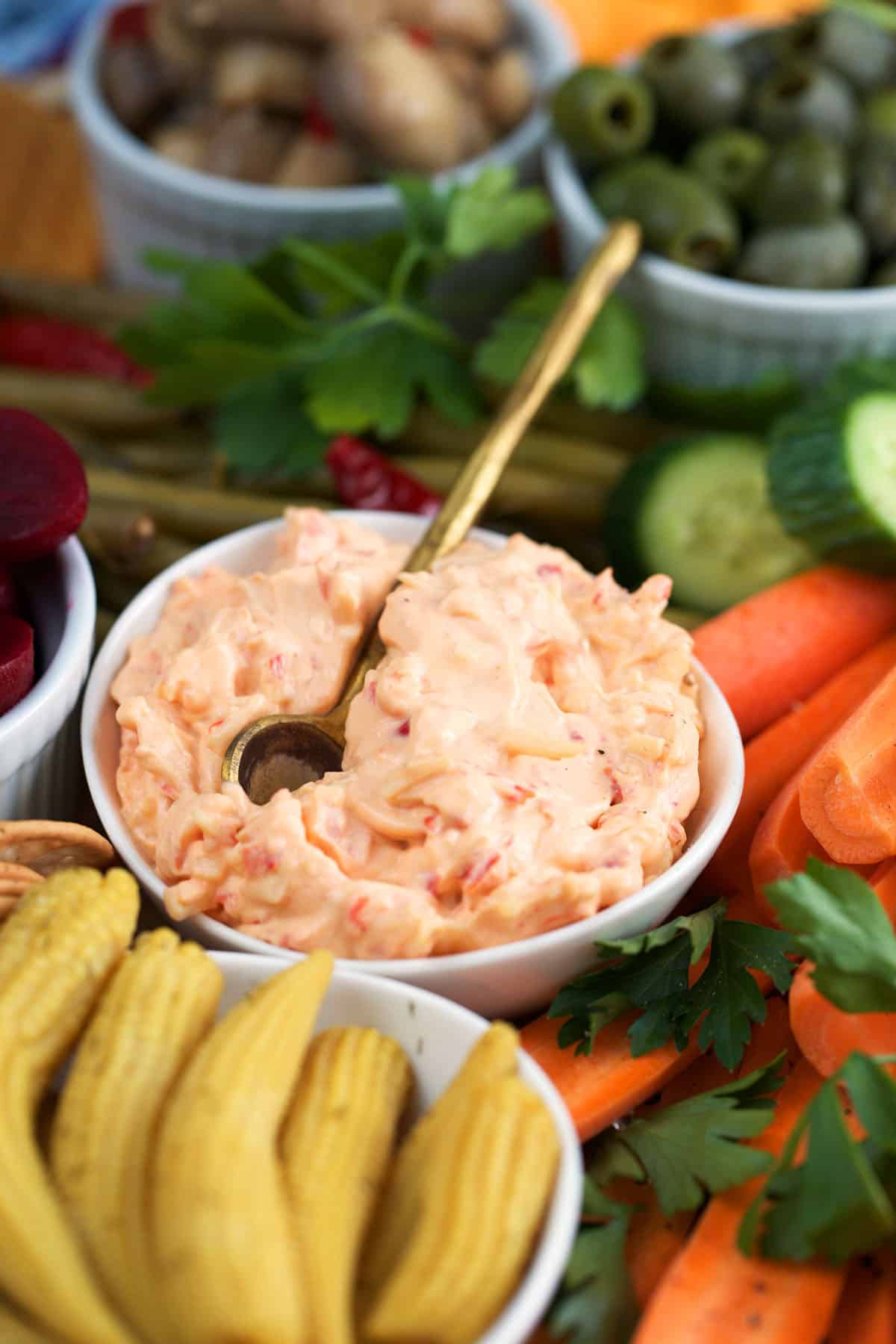 Pimento Cheese in a white bowl on a large relish tray.