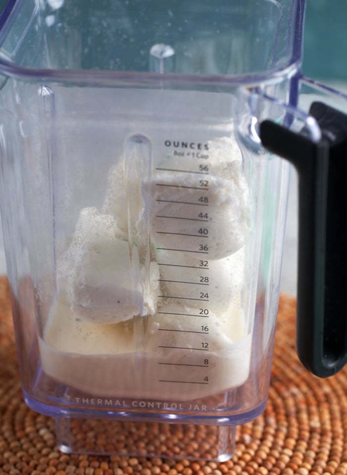 Ingredients in a blender pitcher for a shamrock shake