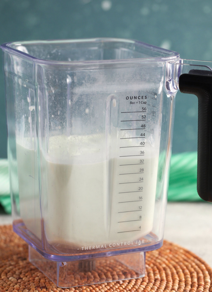 Ingredients for a shamrock shake after it's been blended in a blender pitcher