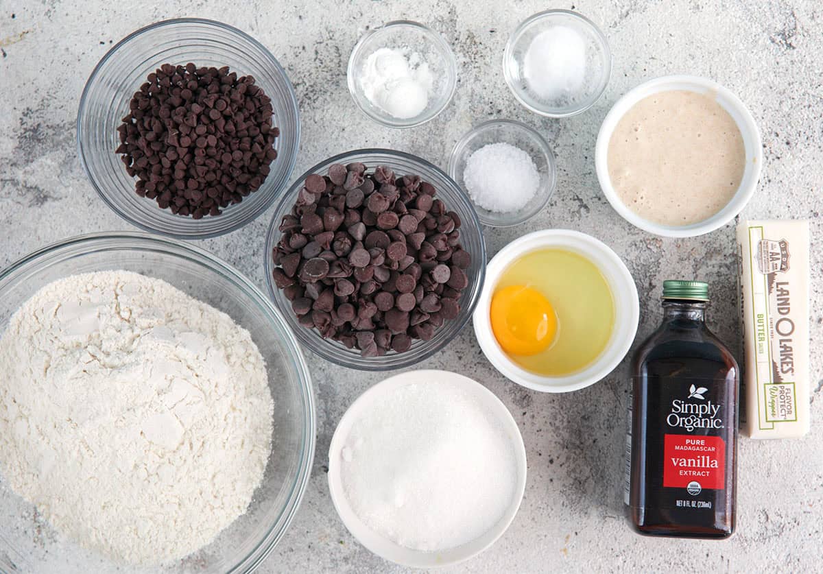 Ingredients for sourdough chocolate chip cookies, flour, sugar, sourdough discard, vanilla, egg, salt, baking powder, baking soda, butter