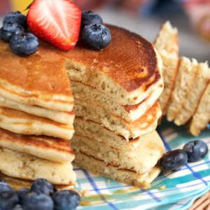 Sourdough discard pancakes made from sourdough starter with a wedge cut out of a stack of pancakes.