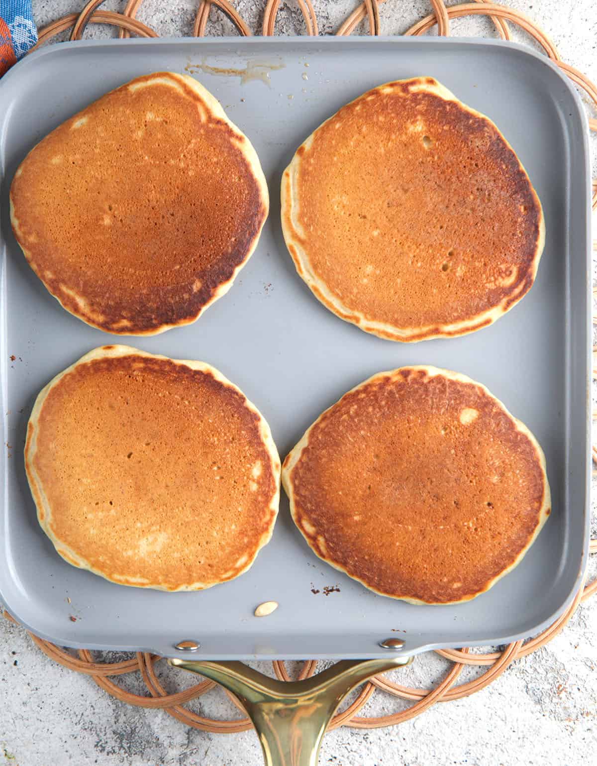 Sourdough pancakes on a griddle pan being Cooked.