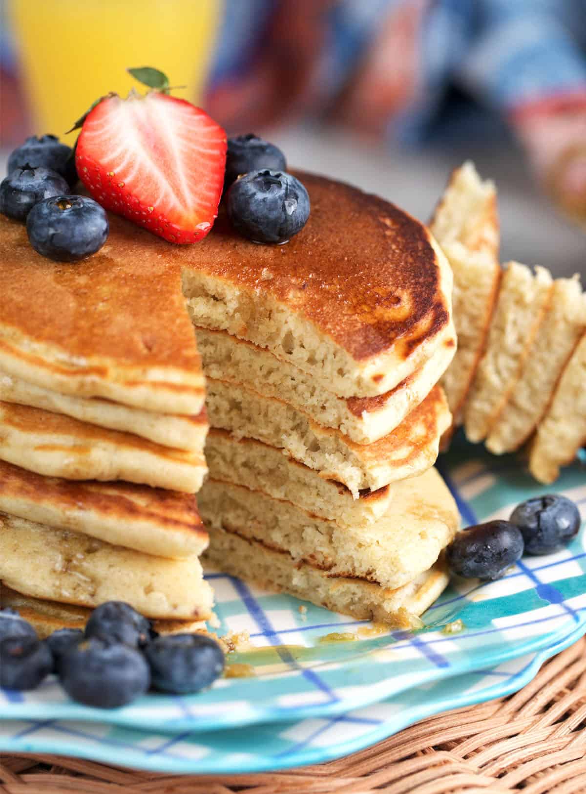 Sourdough discard pancakes made from sourdough starter with a wedge cut out of a stack of pancakes.