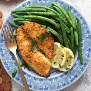 Parmesan Crusted Tilapia on a plate with green beans
