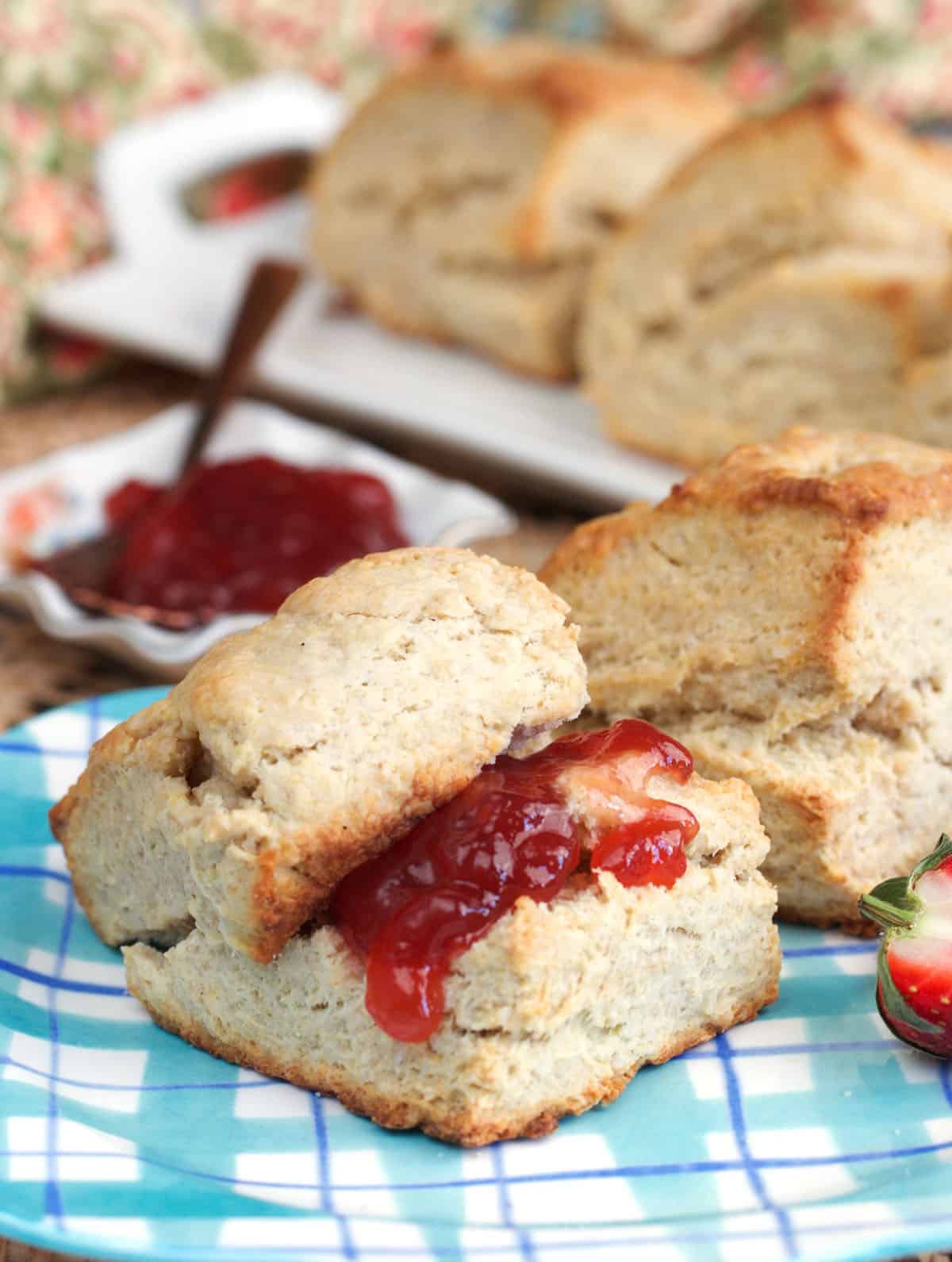 Sourdough discard biscuit cut in half and topped with jam