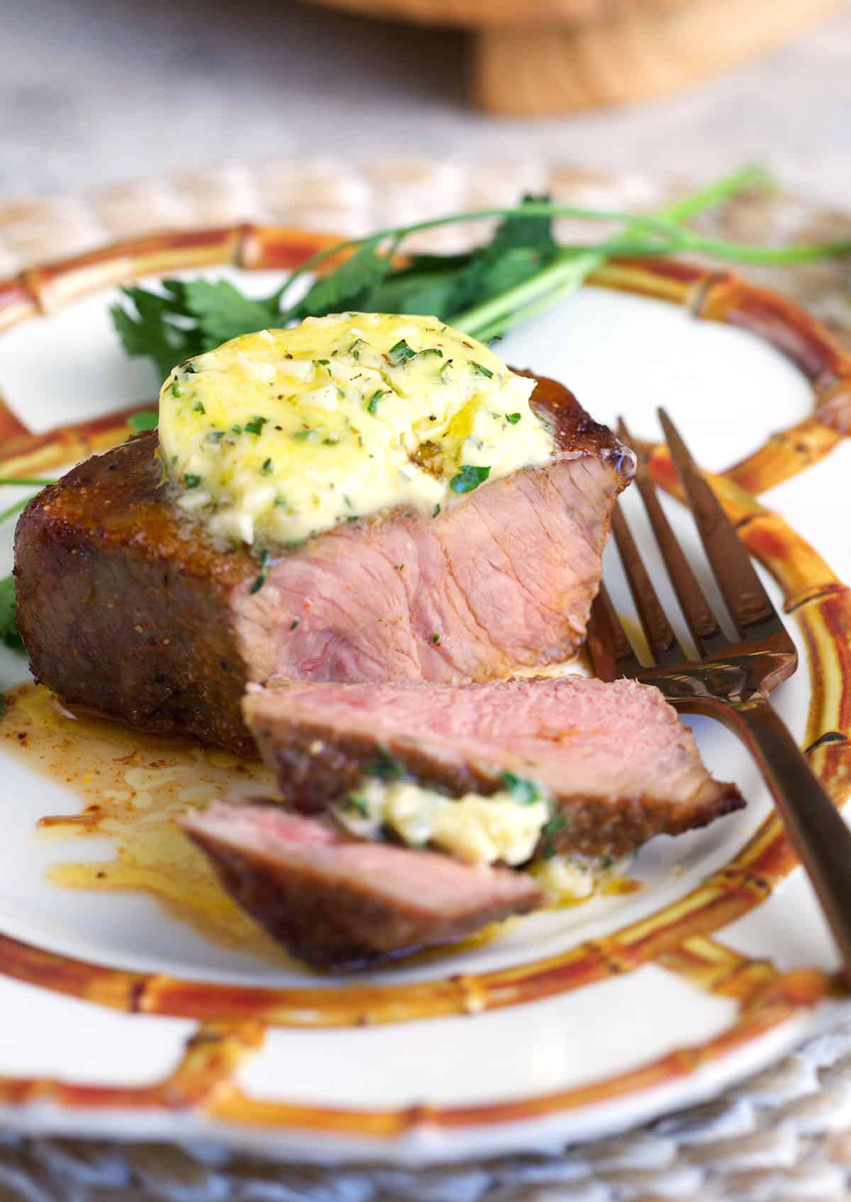 air fryer sirloin steak on a plate with a fork.