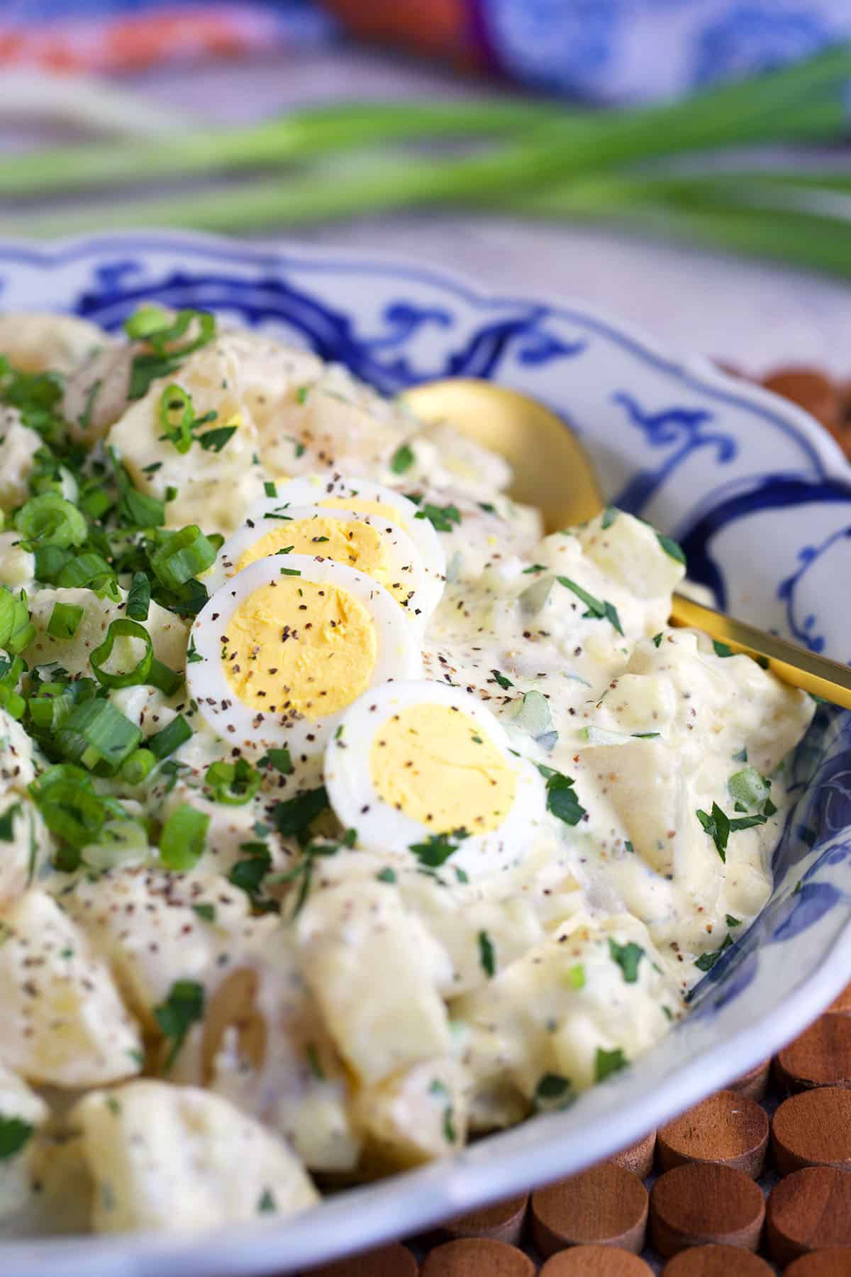 spoon in a bowl of potato salad for serving.