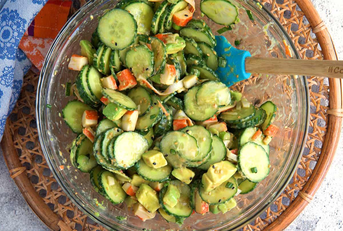 California roll cucumber salad mixed together in a glass mixing bowl.