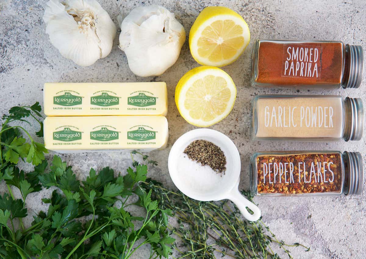 Ingredients for Cowboy Butter, herbs, butter, lemon, garlic and spices.