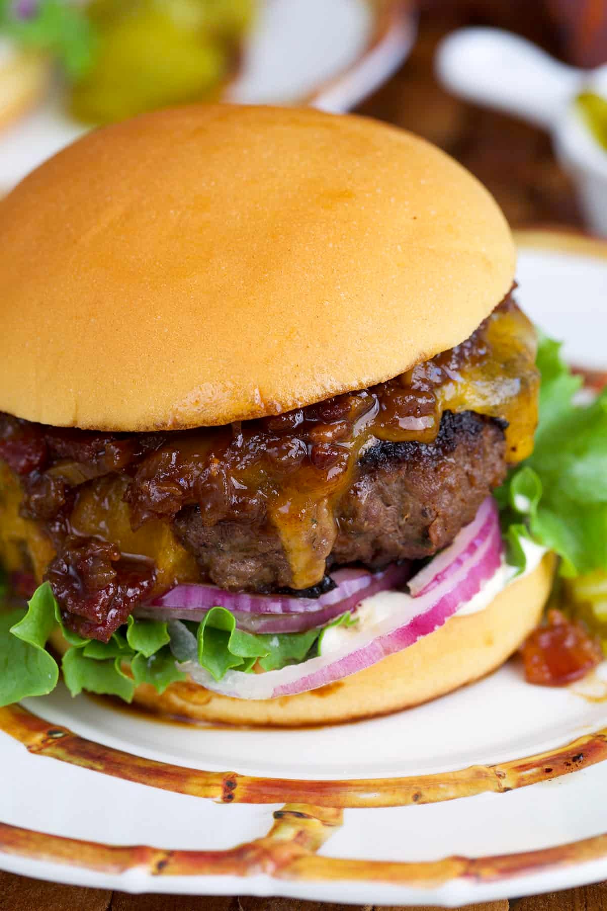 Cracker burger topped with bacon jam on a buttery soft roll