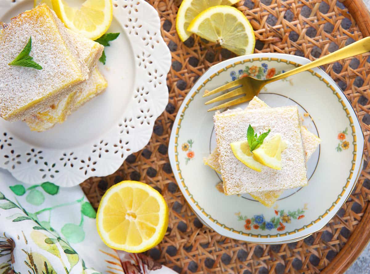 Lemon bars plated with sliced lemons and mint