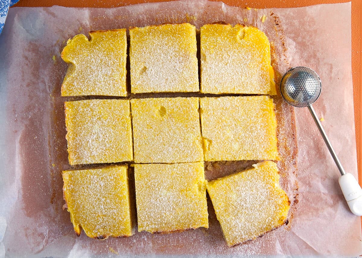 lemon bars on a piece of parchment cut into squares