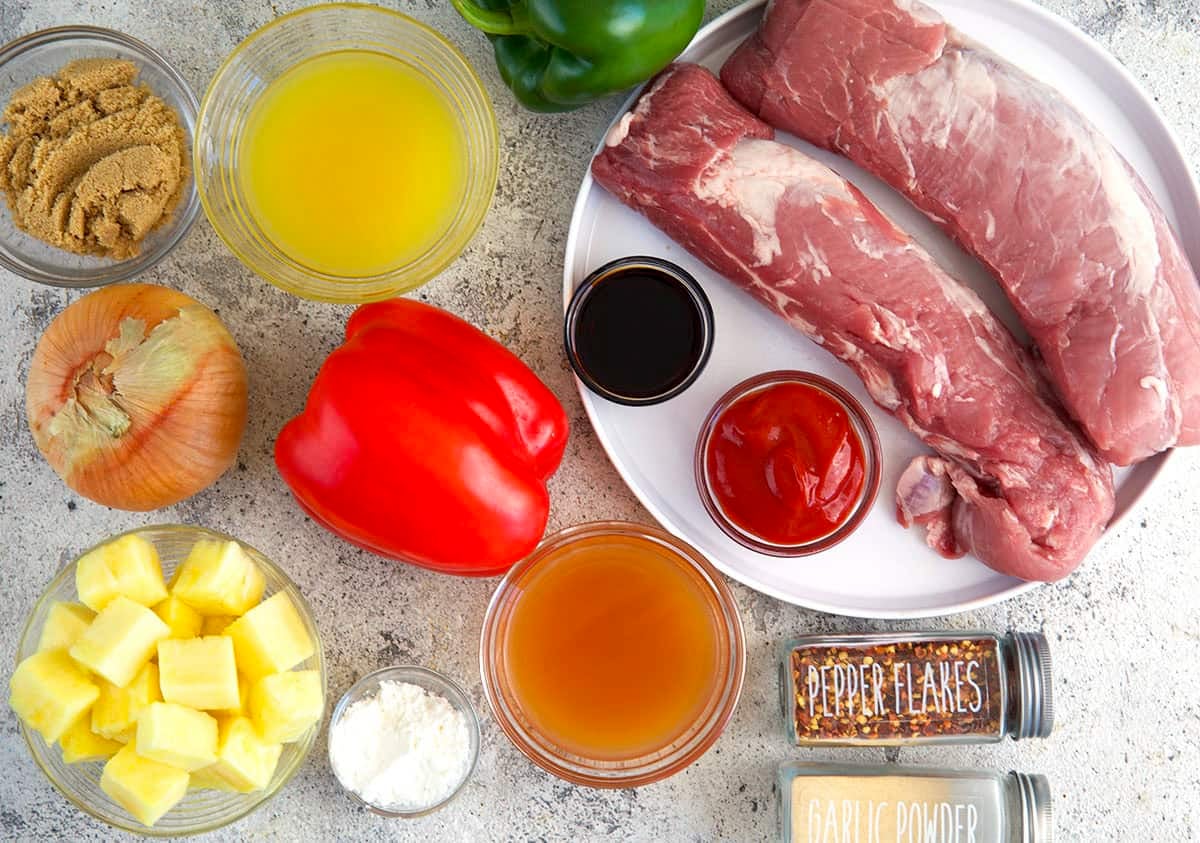 Ingredients for sweet and sour pork, pork tenderloin, veggies, pineapple, spices and pineapple juice.