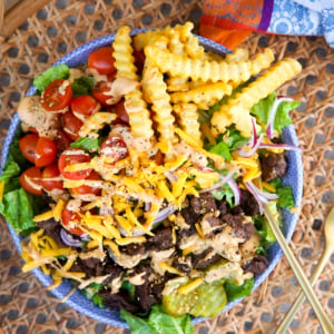 Easy Burger Bowl in a blue and white bowl on a rattan placemat