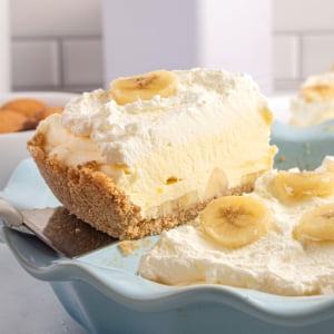 Banana Cream Pie slice being lifted from the pie plate