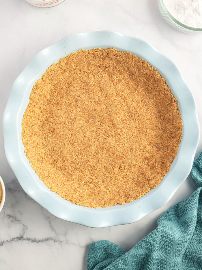 cookie crust in a ceramic pie plate