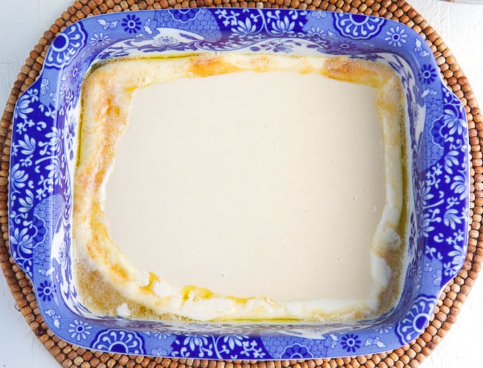 cobbler batter in a baking dish with melted butter