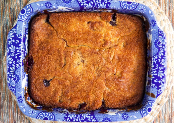 baked cherry cobbler in a blue and white baking dish