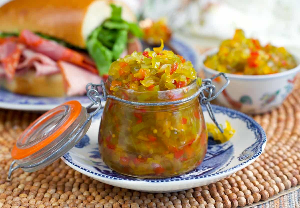 Sweet Pepper Relish on a jar set on a blue and white saucer