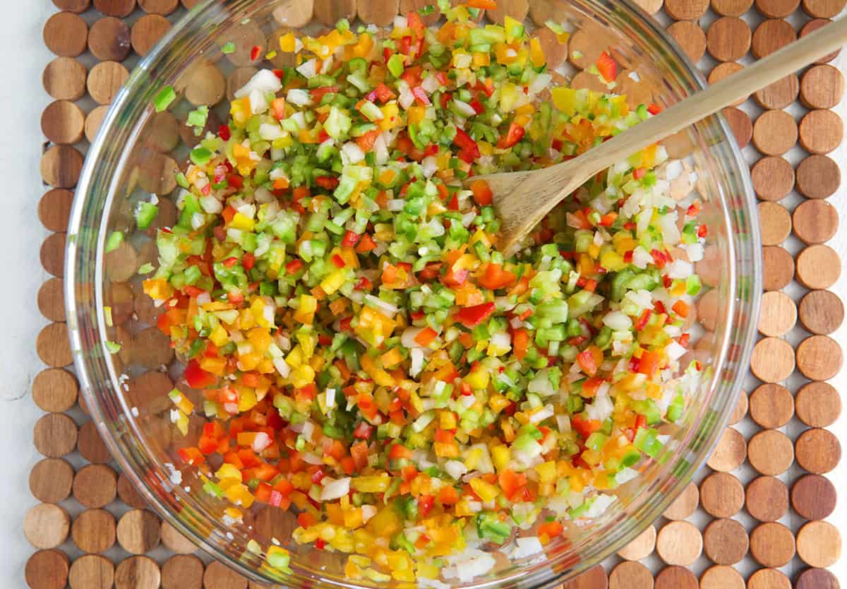 bowl filled with diced ingredients for pepper relish.