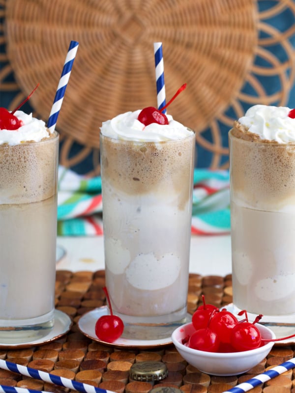 Root Beer Floats with a bowl of maraschino cherries in front of them.