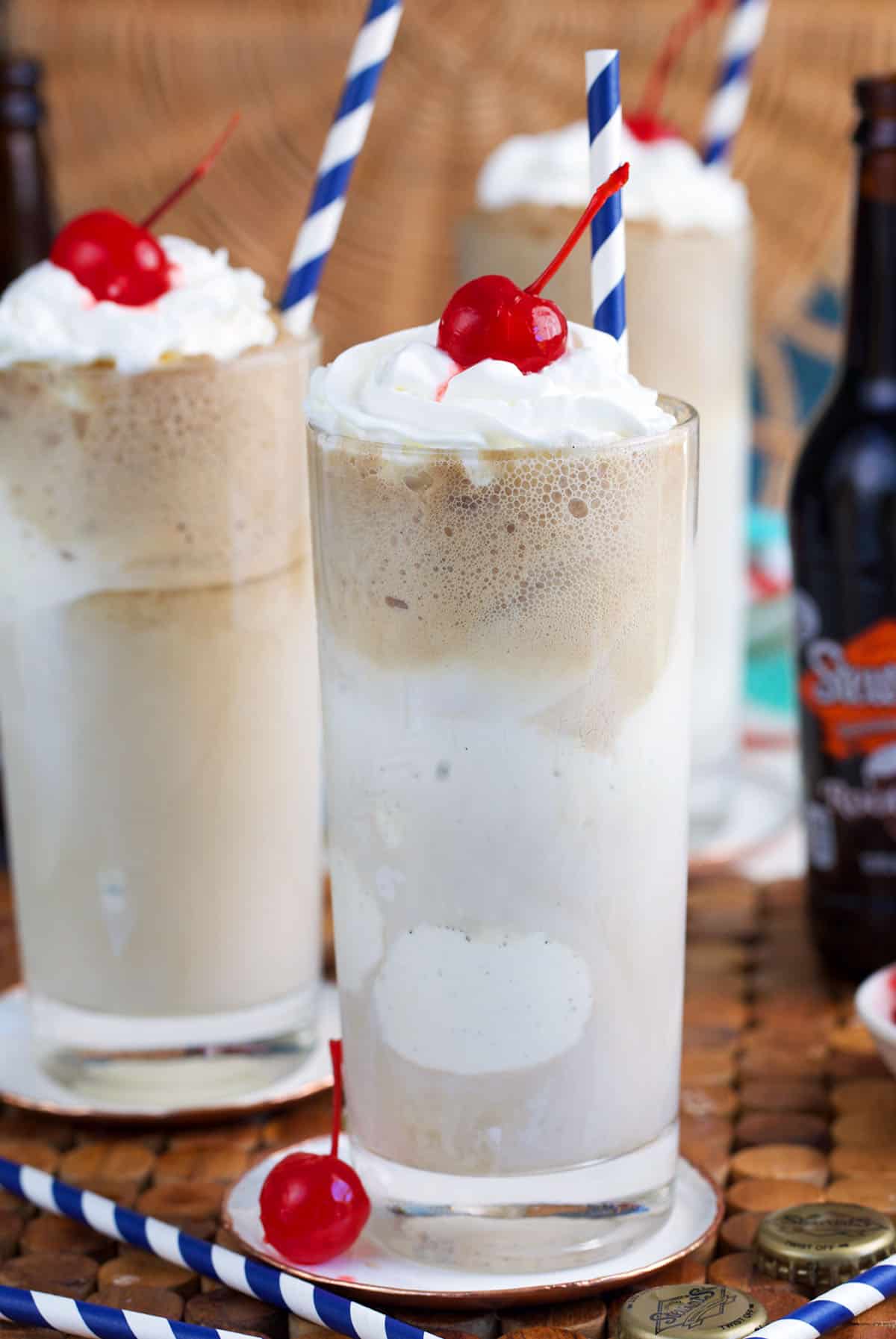 Root Beer float with whipped cream on top and a cherry.