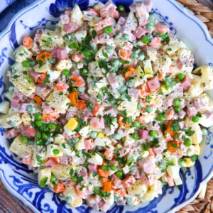 Russian potato salad in a blue and white bowl