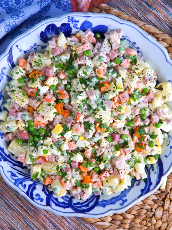 Russian potato salad in a blue and white bowl