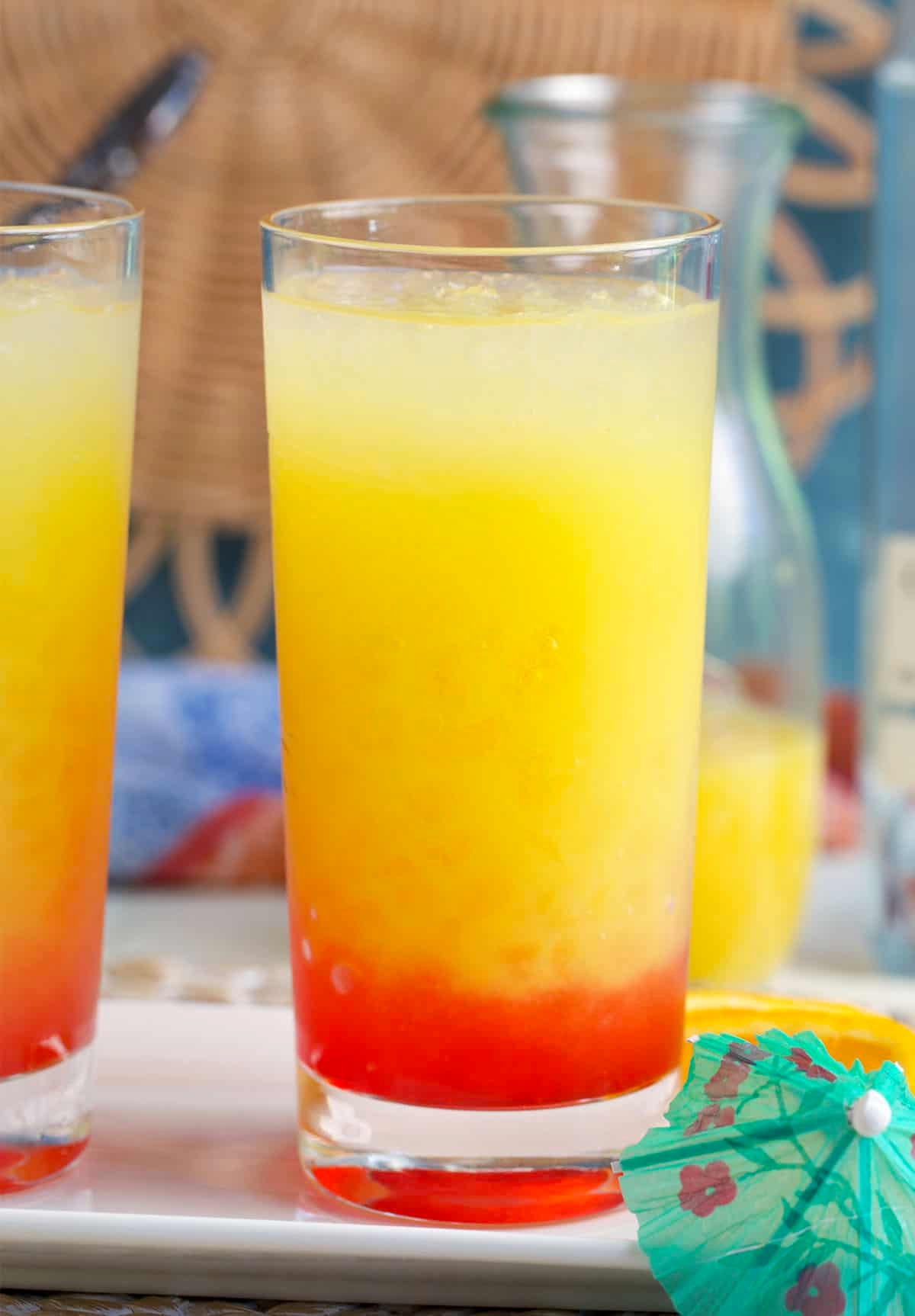 grenadine poured into a glass with orange juice and tequila to make a tequila sunrise.