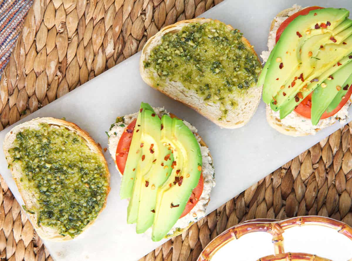 Tunacado sandwich being assembled on a white board.