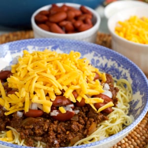Cincinnati Chili on spaghetti in a blue and white floral bowl