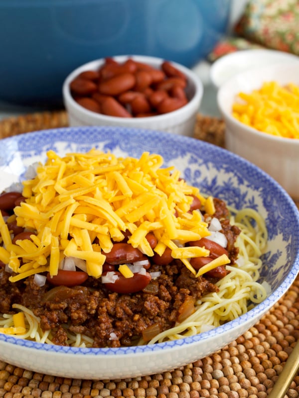 Cincinnati Chili on spaghetti in a blue and white floral bowl